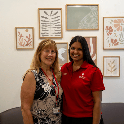 Two caps staff standing in their office
