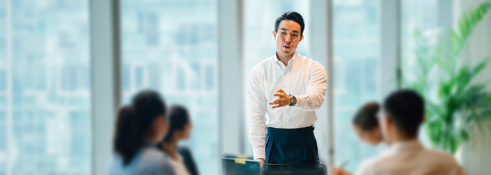 Man presenting in front of a group.