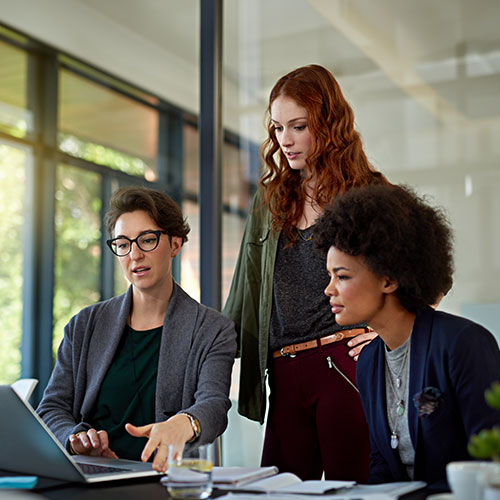 Three women looking at a computer