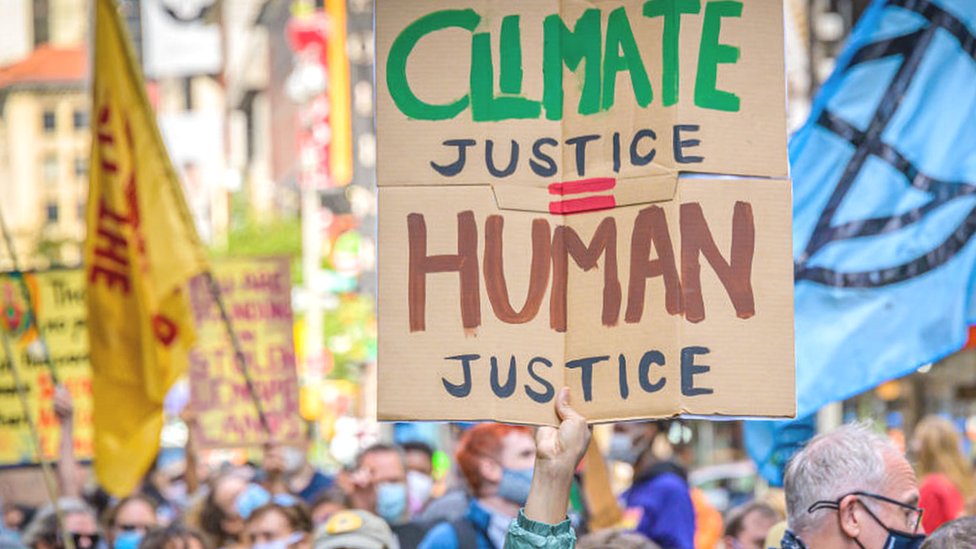 handmade sign "climate justice = human justice"