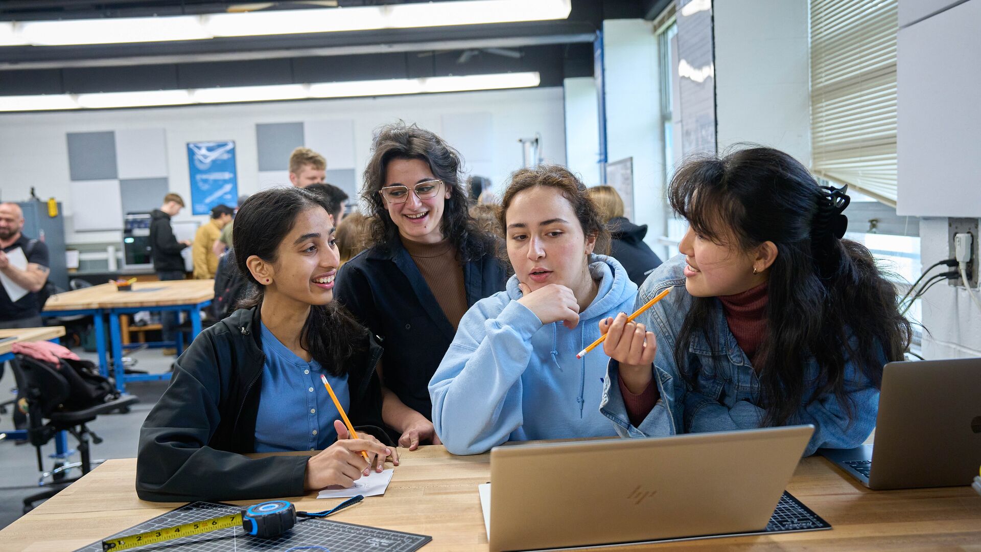 Student talking and working together at a table.