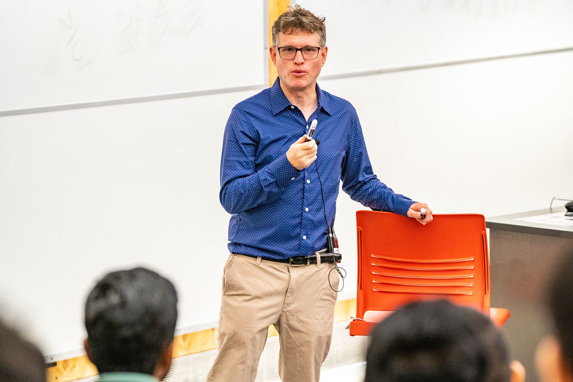 Professor teaching course in lecture hall.