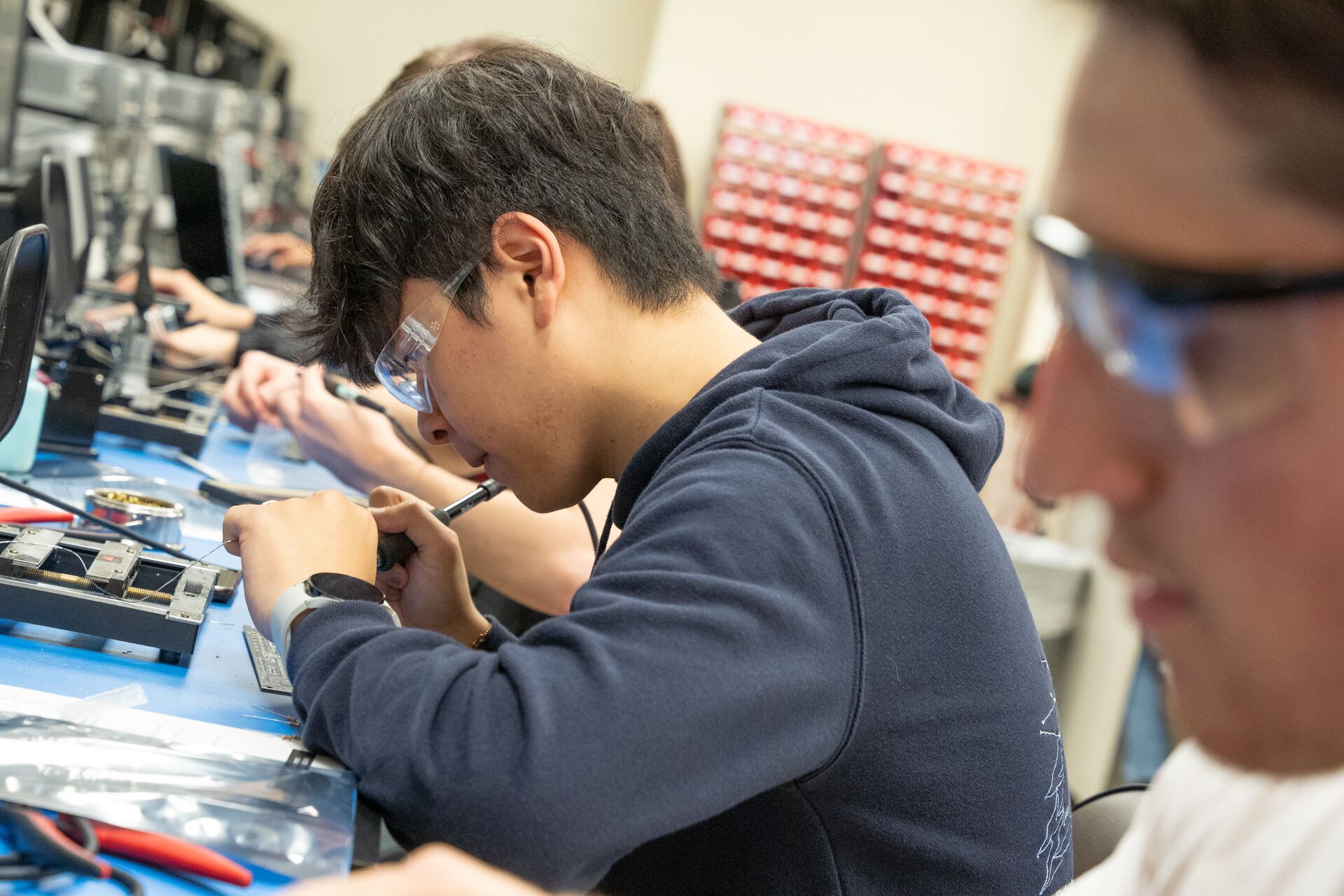 Student working with circuts at a desk.