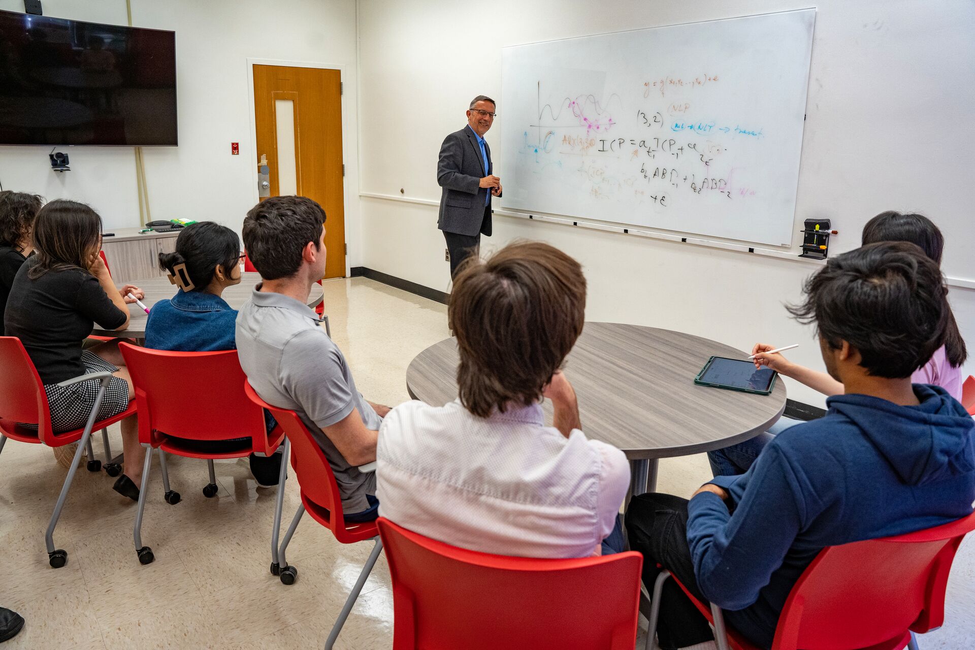 Professor teaching students in a classroom.