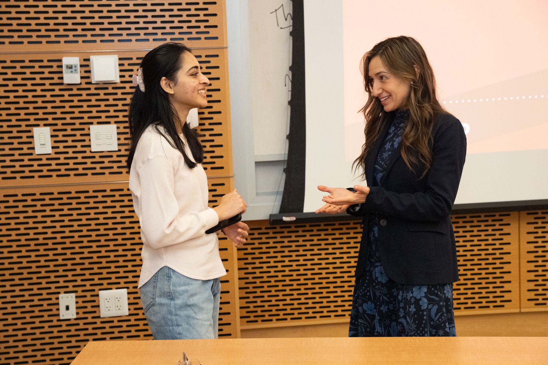 Two individuals talking at a student event.