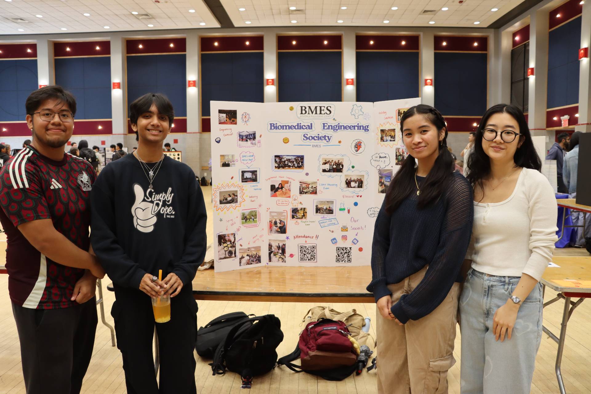 Students standing in front of a poster board for Biomedical Engineering Society.