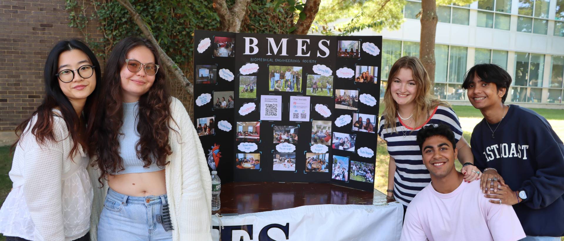 Students standing in front of a poster board that says BMES