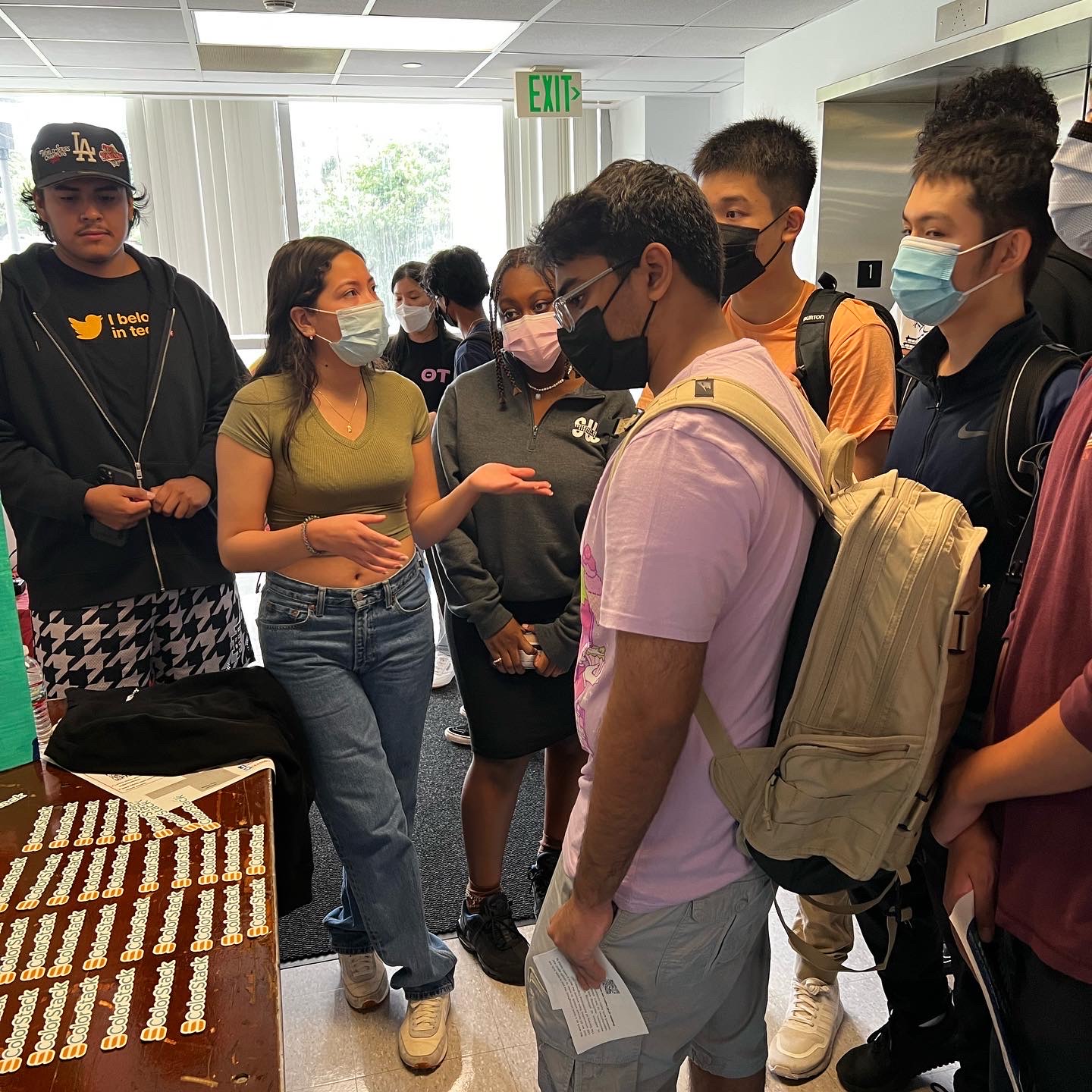Students speaking in a hallway.