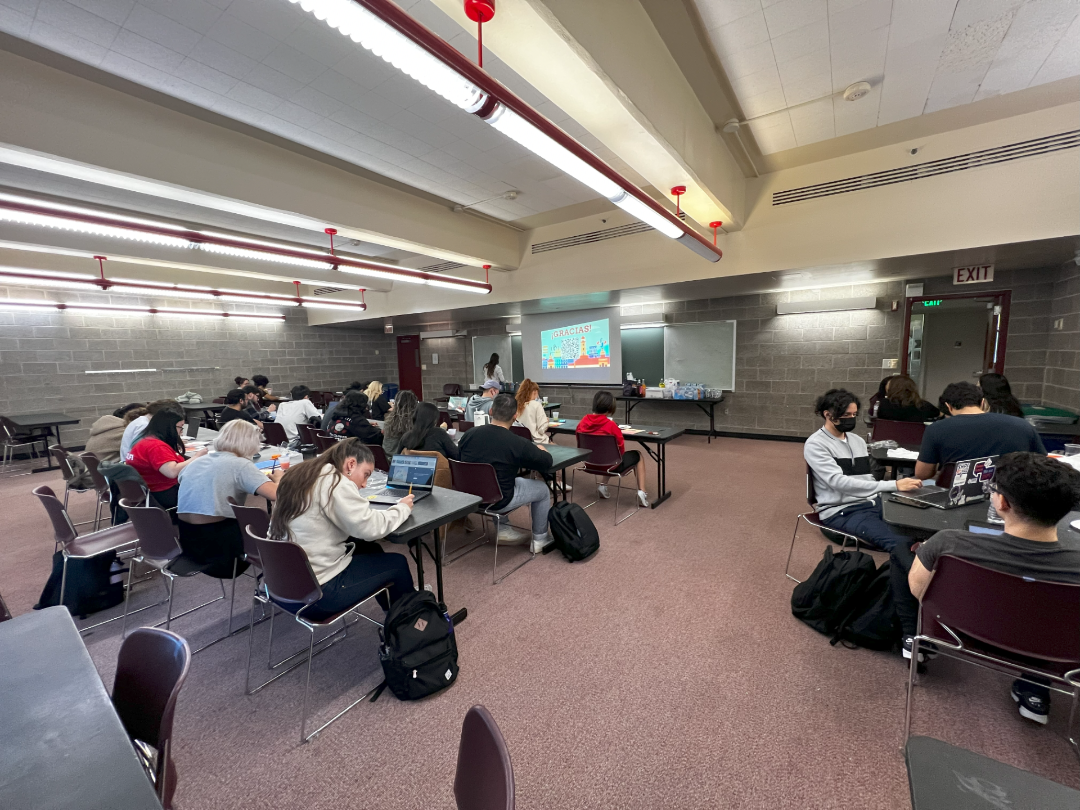 Students sitting in a classroom taking notes.