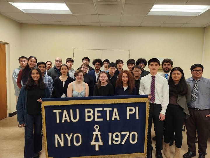 Students holding a banner that says Tau Beta Pi
