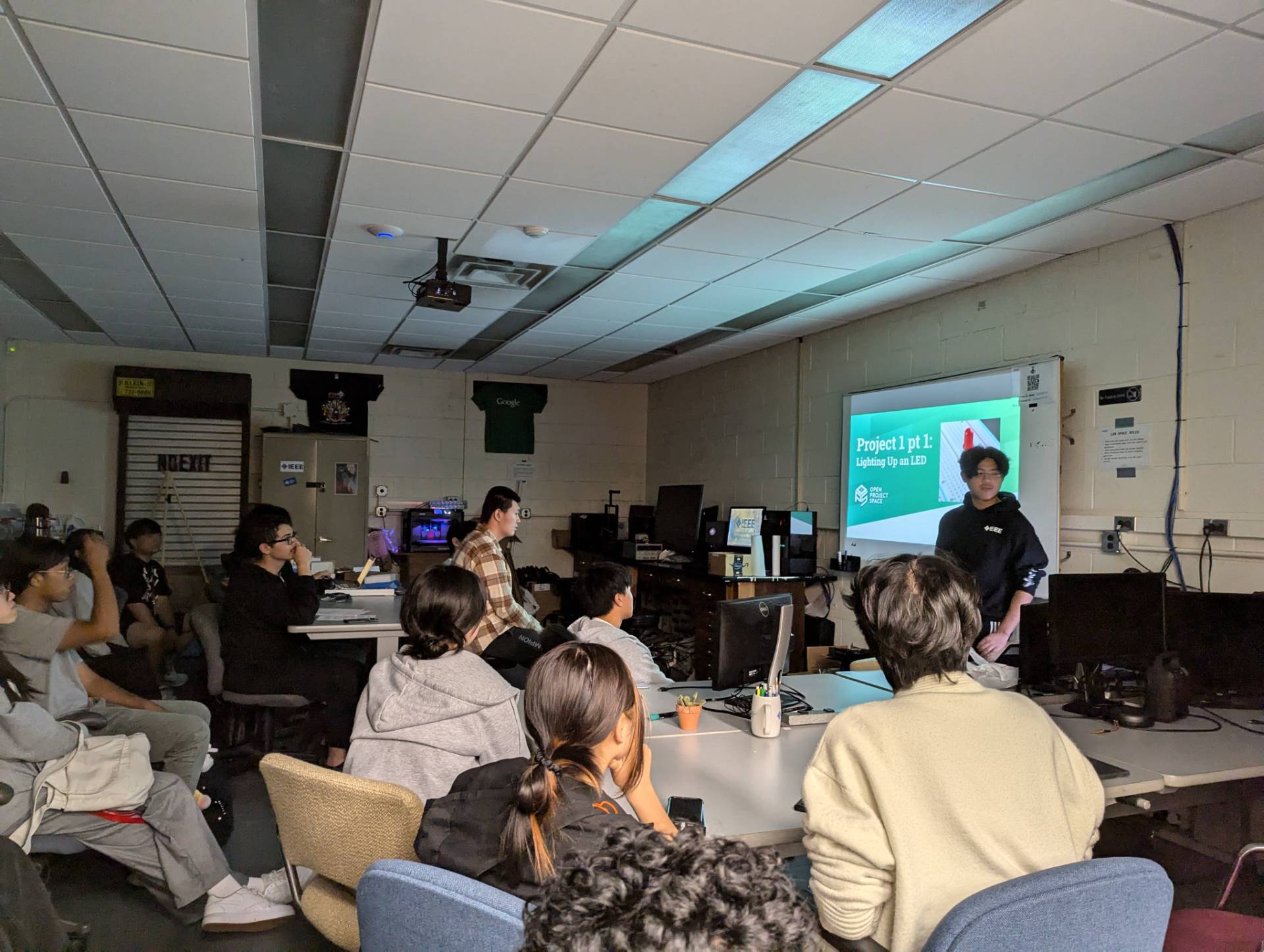 People sitting in a classroom listening to a presentation.