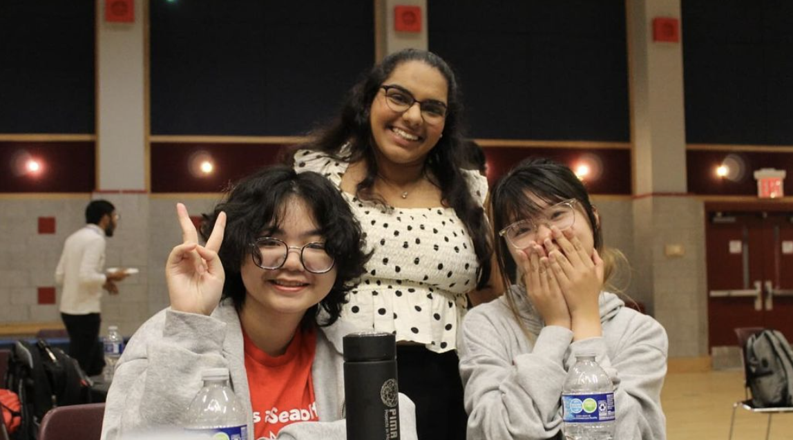 Students smiling, one holding up a peace sign.