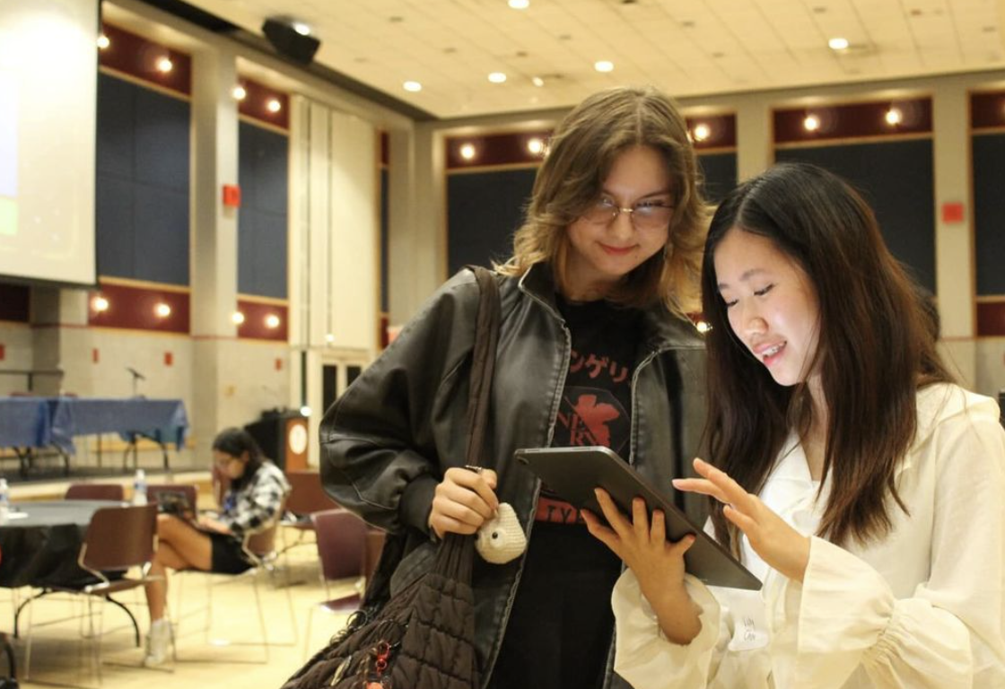 Two individuals looking at an iPad.