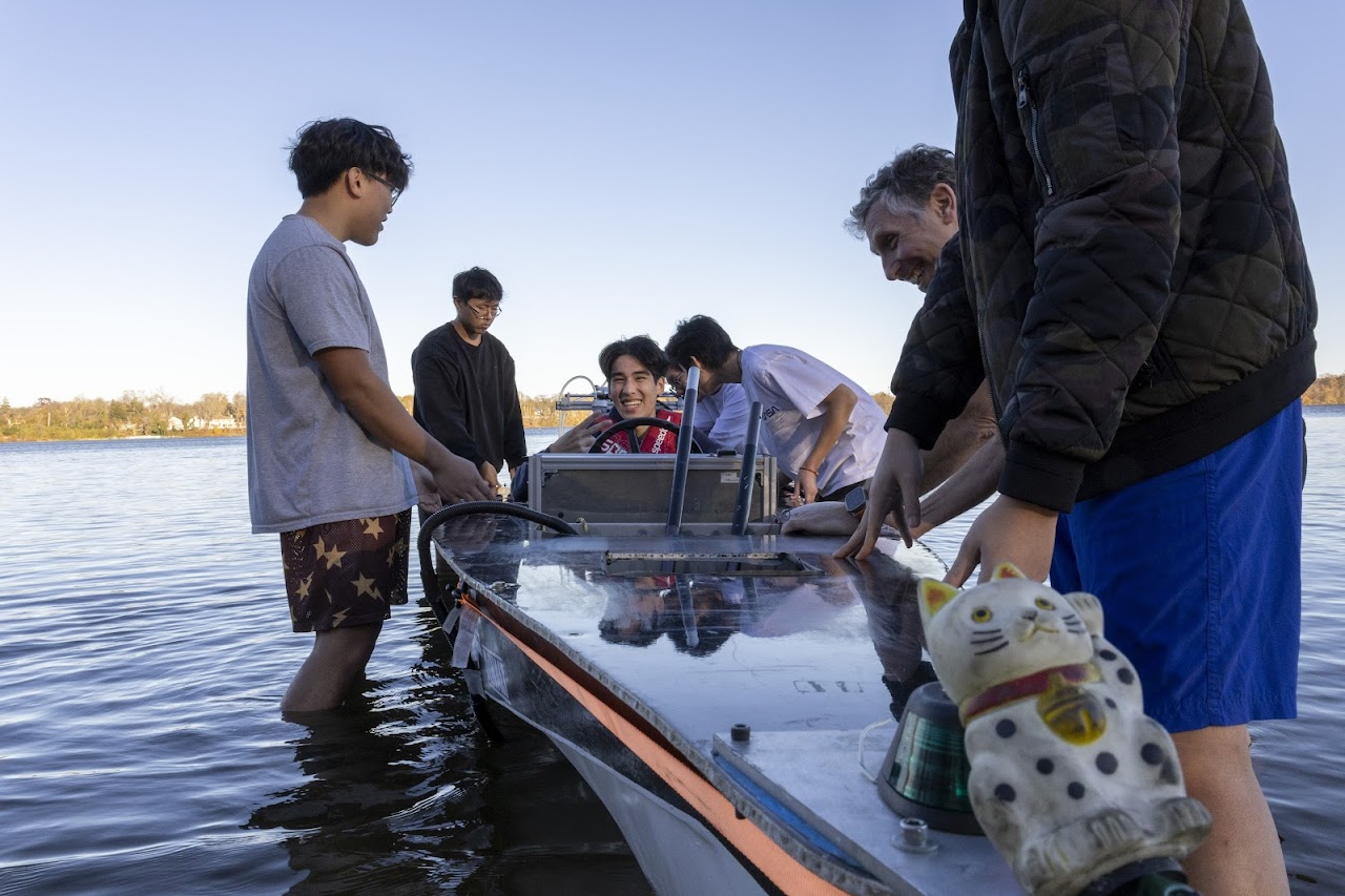 People in the water working on a boat.