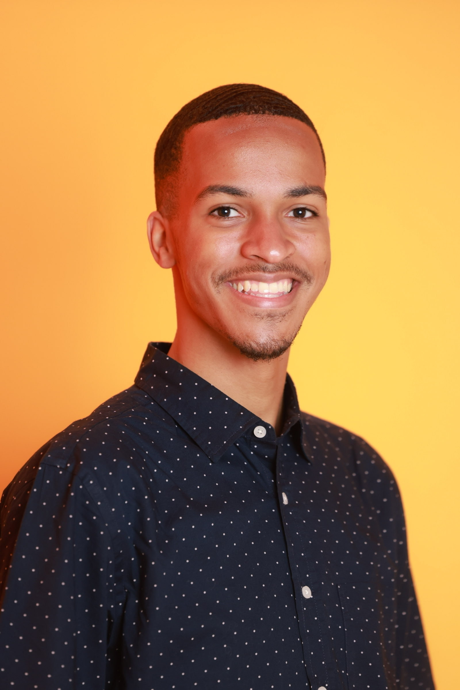 Justin Harper portrait with a yellow background