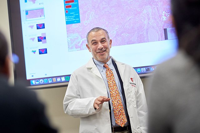 Dr. Joel Saltz teaching in front of a slide