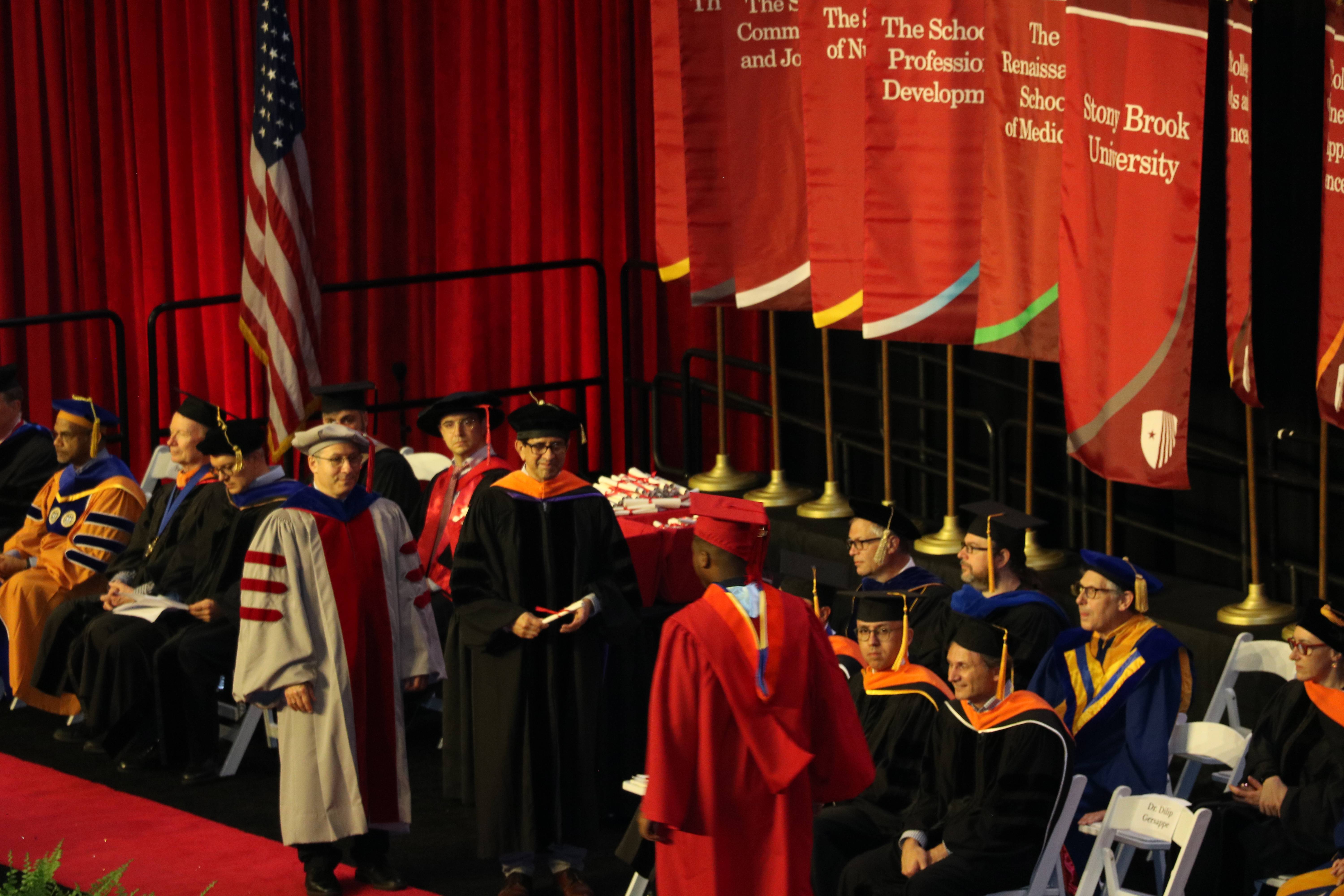 Graduates crossing the stage at Stony Brook University Commencement