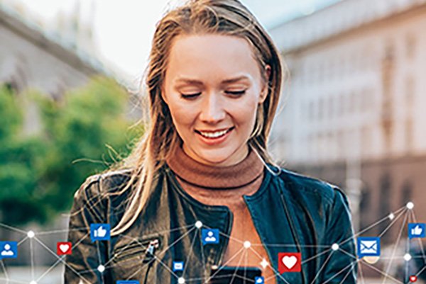 Department of Technology and Society A woman smiling (head and shoulders) looking at her cell phone and images of social media icons such as hearts and thumbs up form a border at bottom