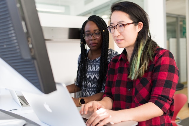 Students collaborating around a computer