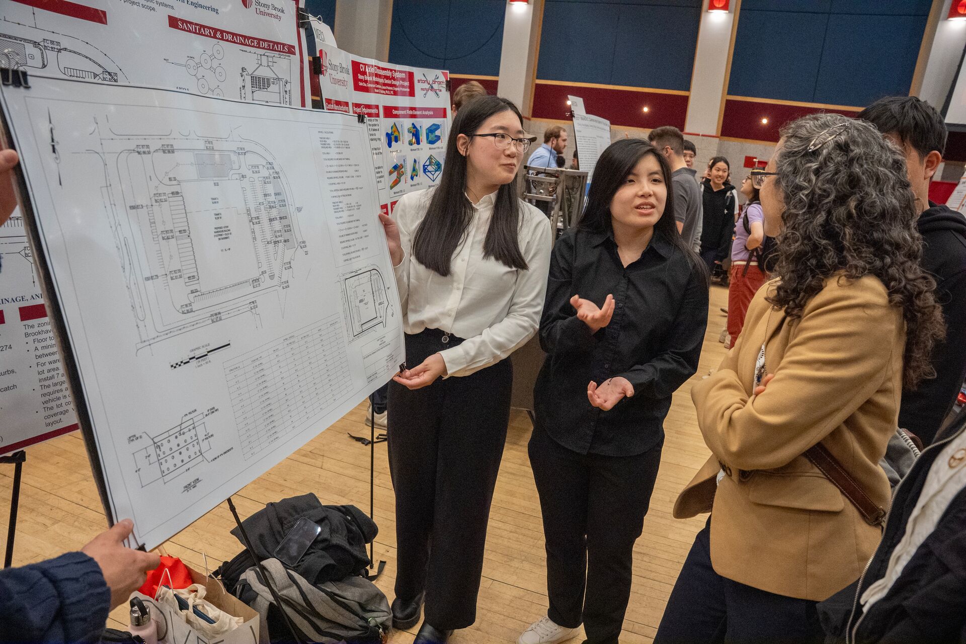 Two senior students presenting their poster at Senior Design Seminar