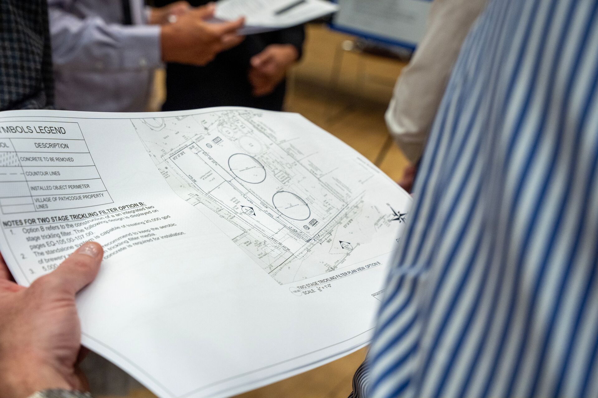 student holding a design plan