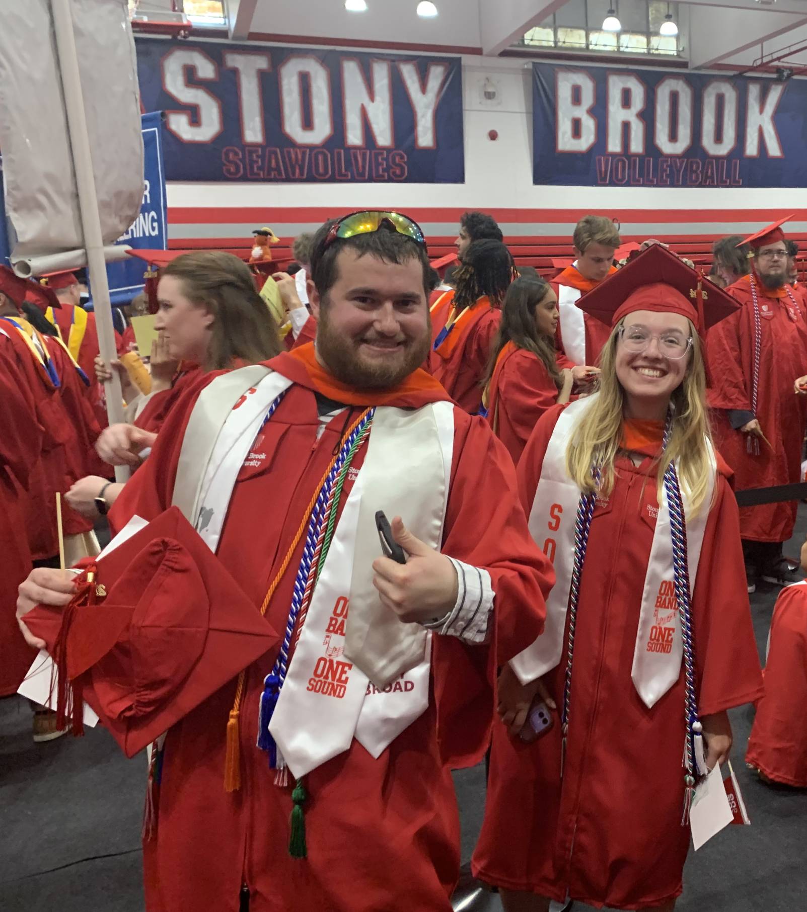 excited students in regalia before commencement