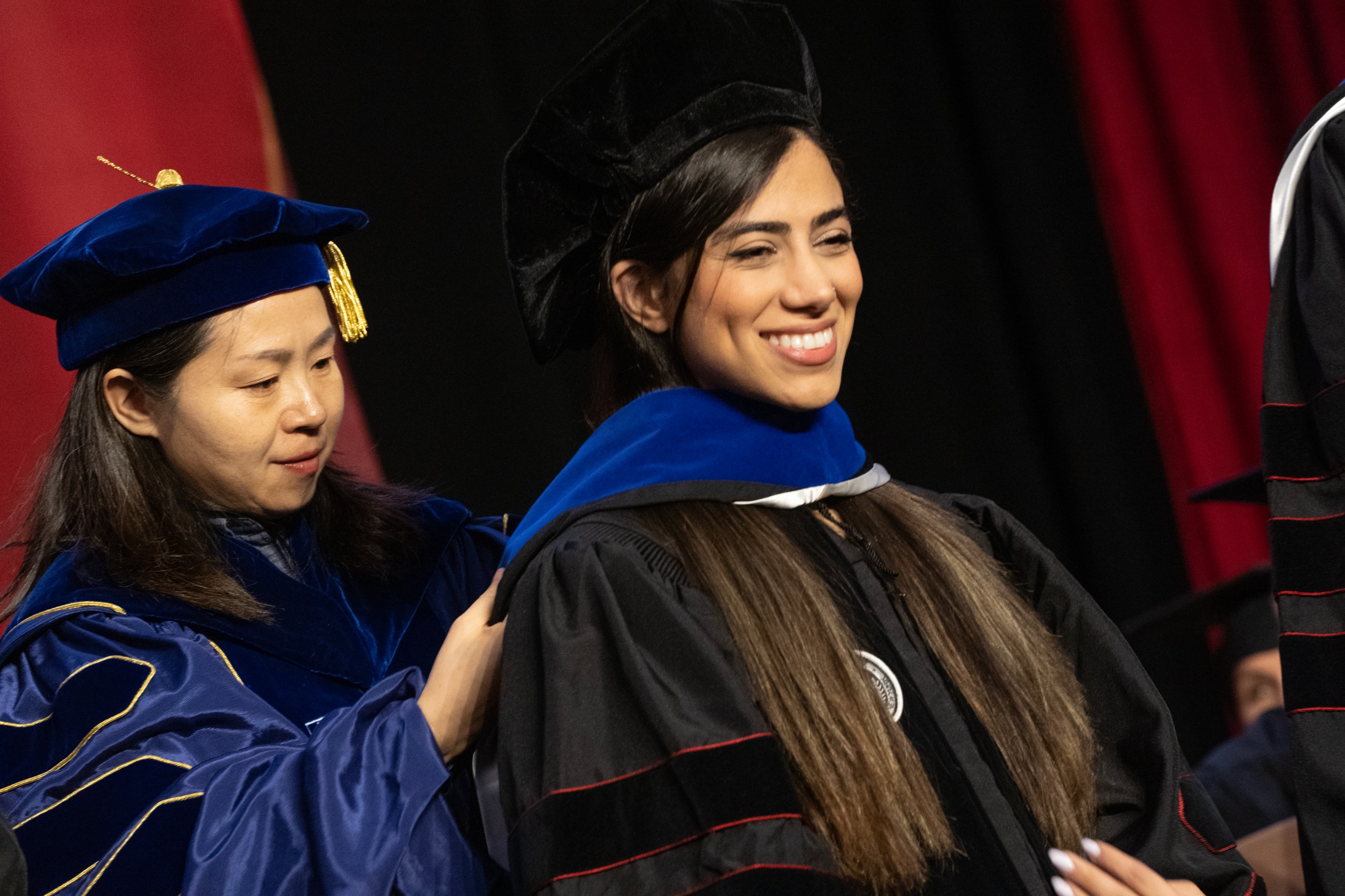 Mahsa Bargahi being hooded by Ruwen Qin