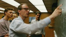 Professor Robert Shrock and graduate student Victor Matveev (left) explaining their work on spin systems in an external magnetic field to Professor George Sterman and graduate student Nikolaos Kidonakis.