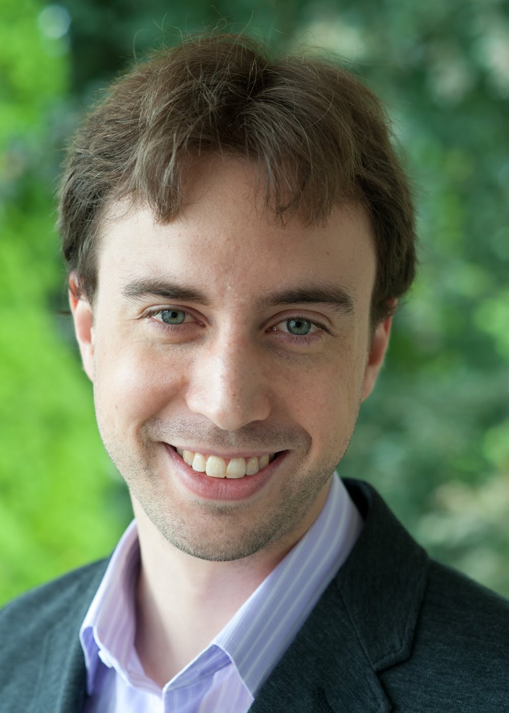Headshot of Braden Brinkman standing in front of trees