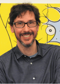 Headshot of Alfredo Fontanini standing in front of a yellow and gray painting