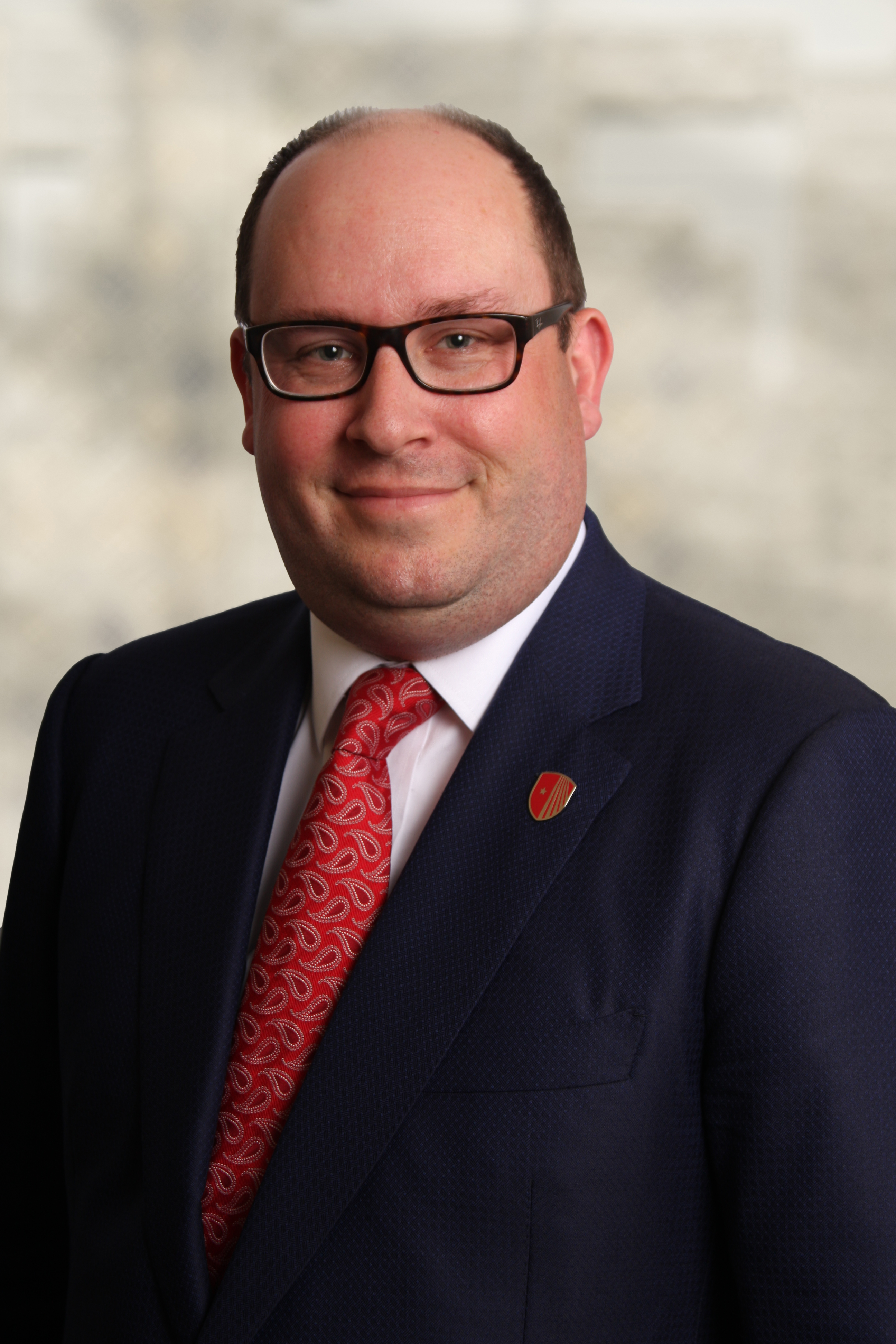 Michael D'Ambrosio Michael D'Ambrosio, wearing a dark blue suit and red tie