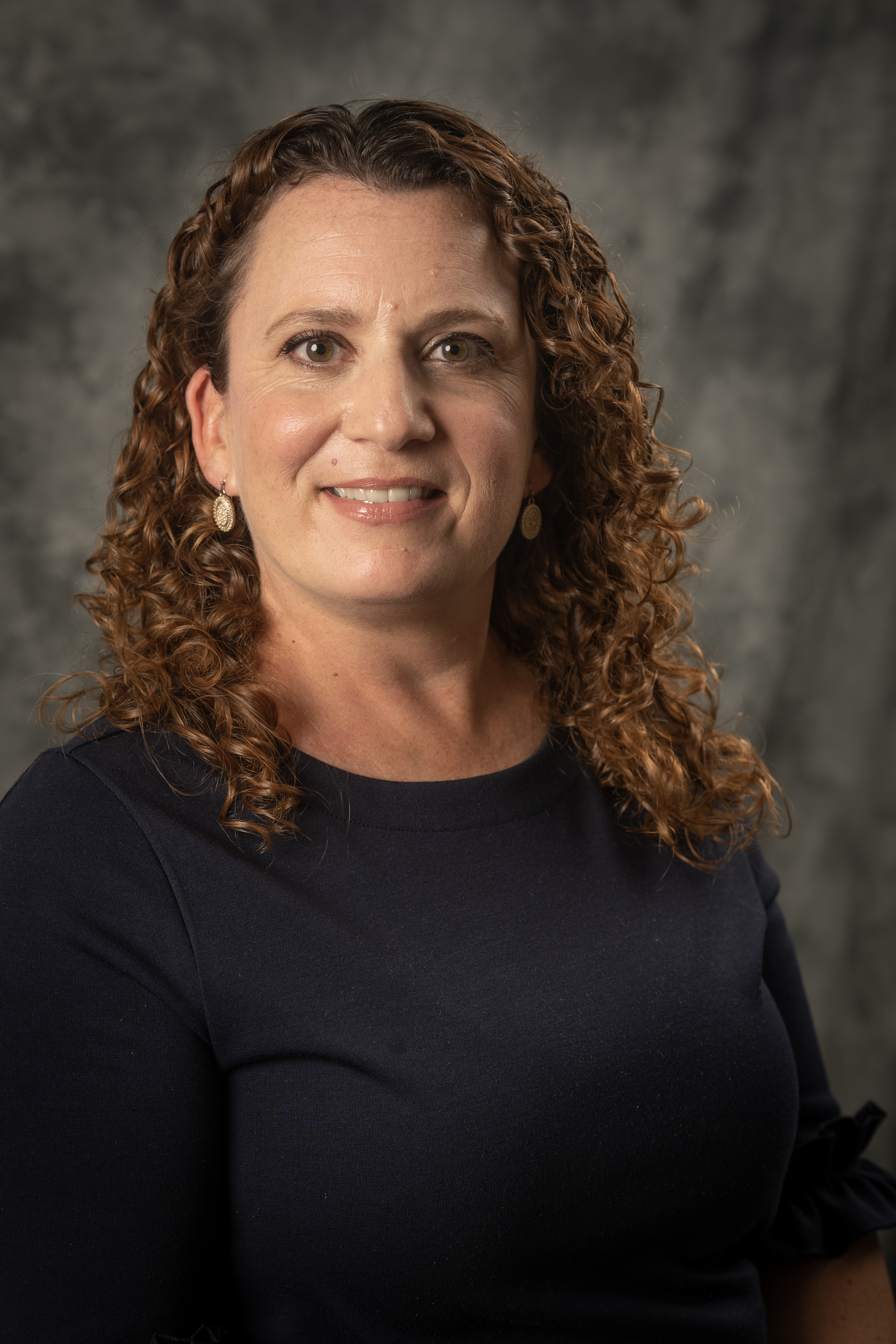 Lauren Donovan Lauren Donovan, with a black shirt and curly brown hair smiling
