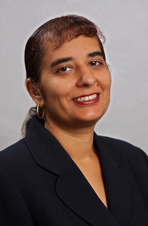 Surita Bhatia Surita Bhatia, wearing a black professional top and smiling