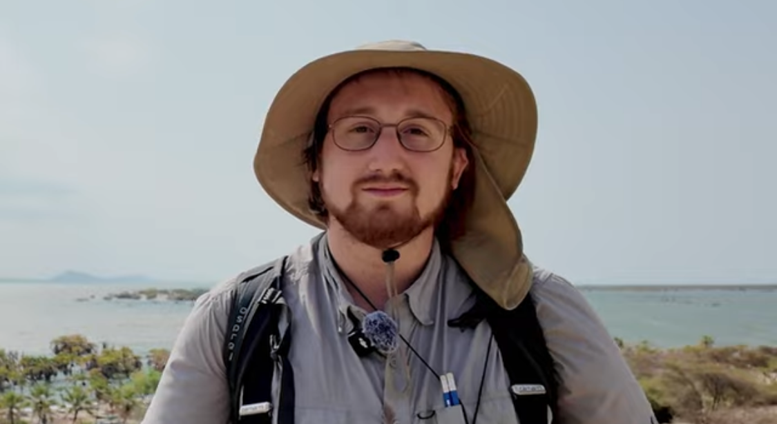 Male wearing a tan bucket hat outdoors