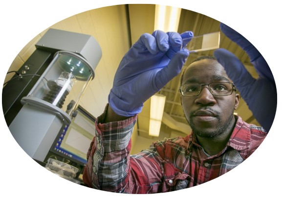 Student holding microscope slide