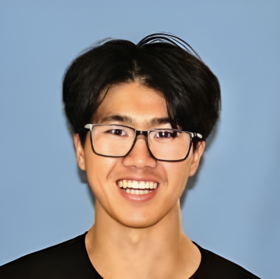 Person in a black shirt smiling, standing in front of a blue background.