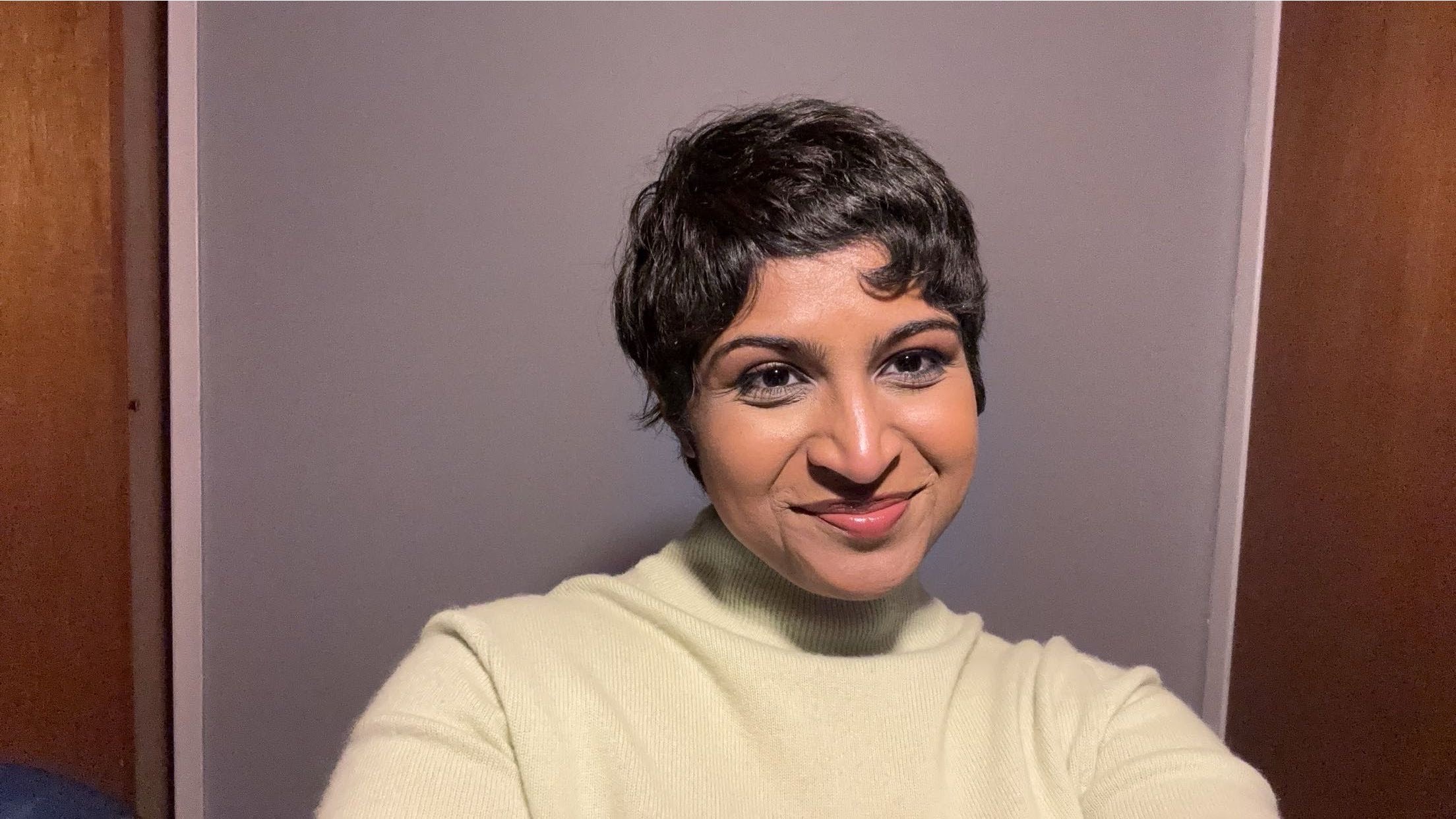Varghese, wearing an off-white turtleneck