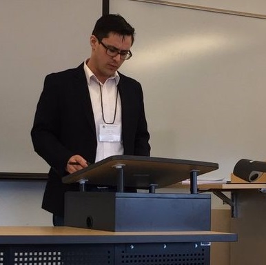 Photograph of Stephen Pallas standing at a lectern