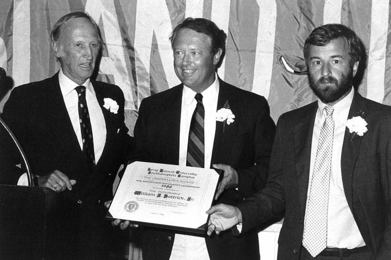 Southampton College chancellor Angier Biddle Duke (left) and provost Tim Bishop (right) present Southampton mayor William Hatrick with the Chancellors Award in 1986.