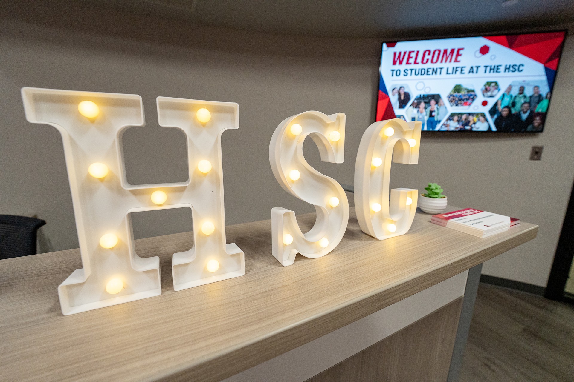Light-up letters spelling out "HSC"