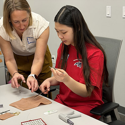 A student practices suturing.