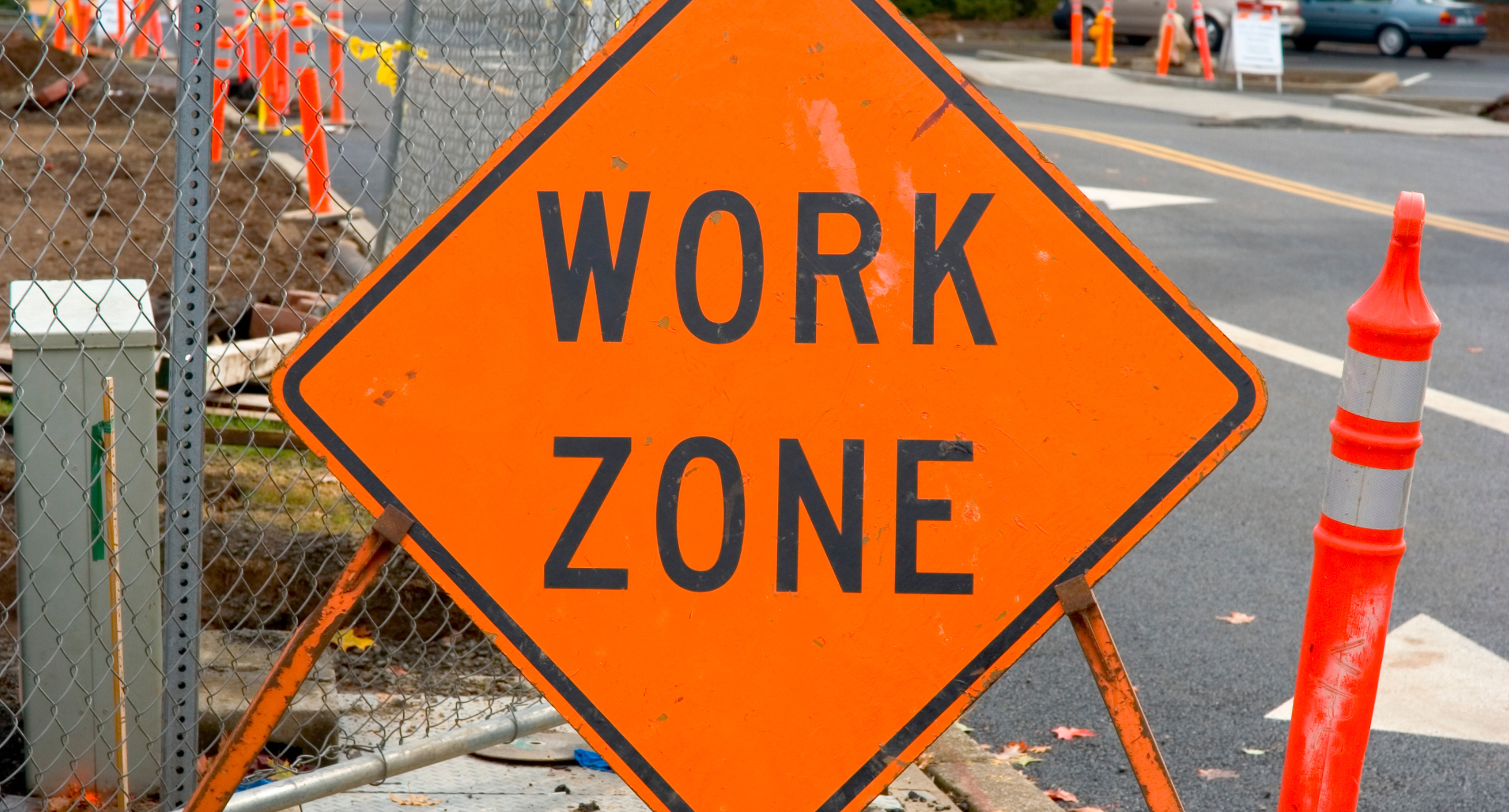 work zone sign in foreground construction zone background