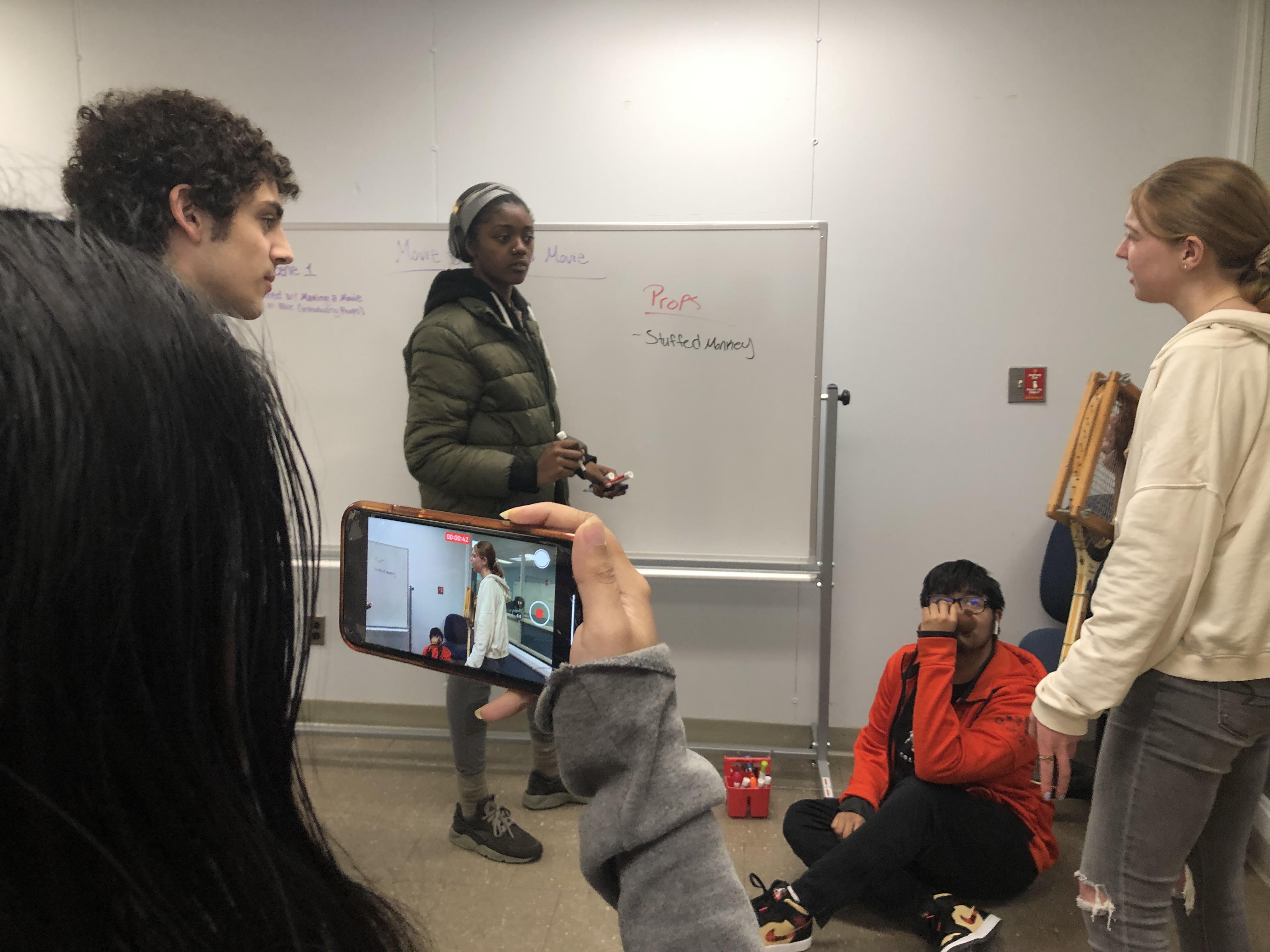 student filming with phone