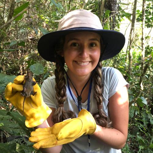 Sarah Varacco holding a tenrec in the Ranomafana National Park, Madagascar.