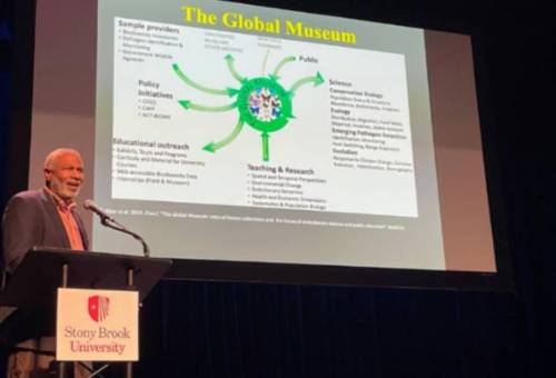 photo of a speaker in front of the podium during a Darwin Day talk