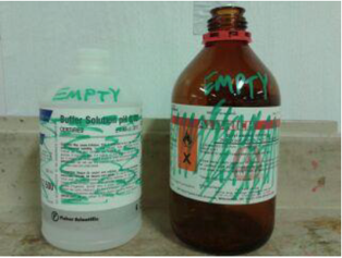 image of two previously used bottles which are now empty. the labels on the bottles have been scribbled out, using a marker