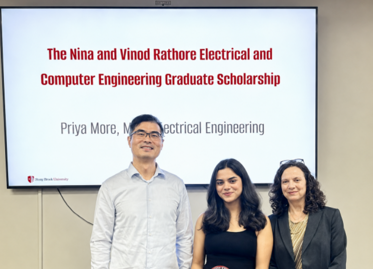 Photo of student and 2 professors celebrating the student's achievement.
