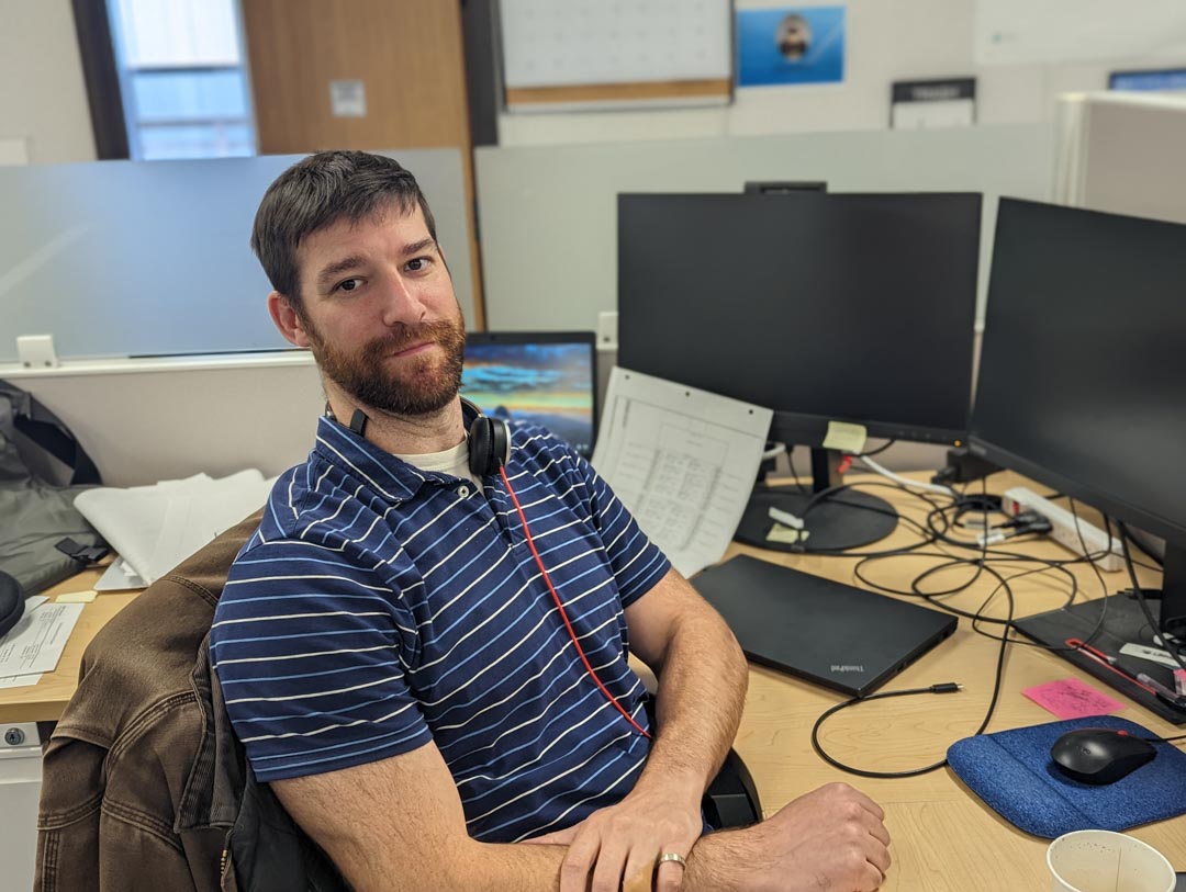 Colin Dornemann at a desk leaning back in a chair.