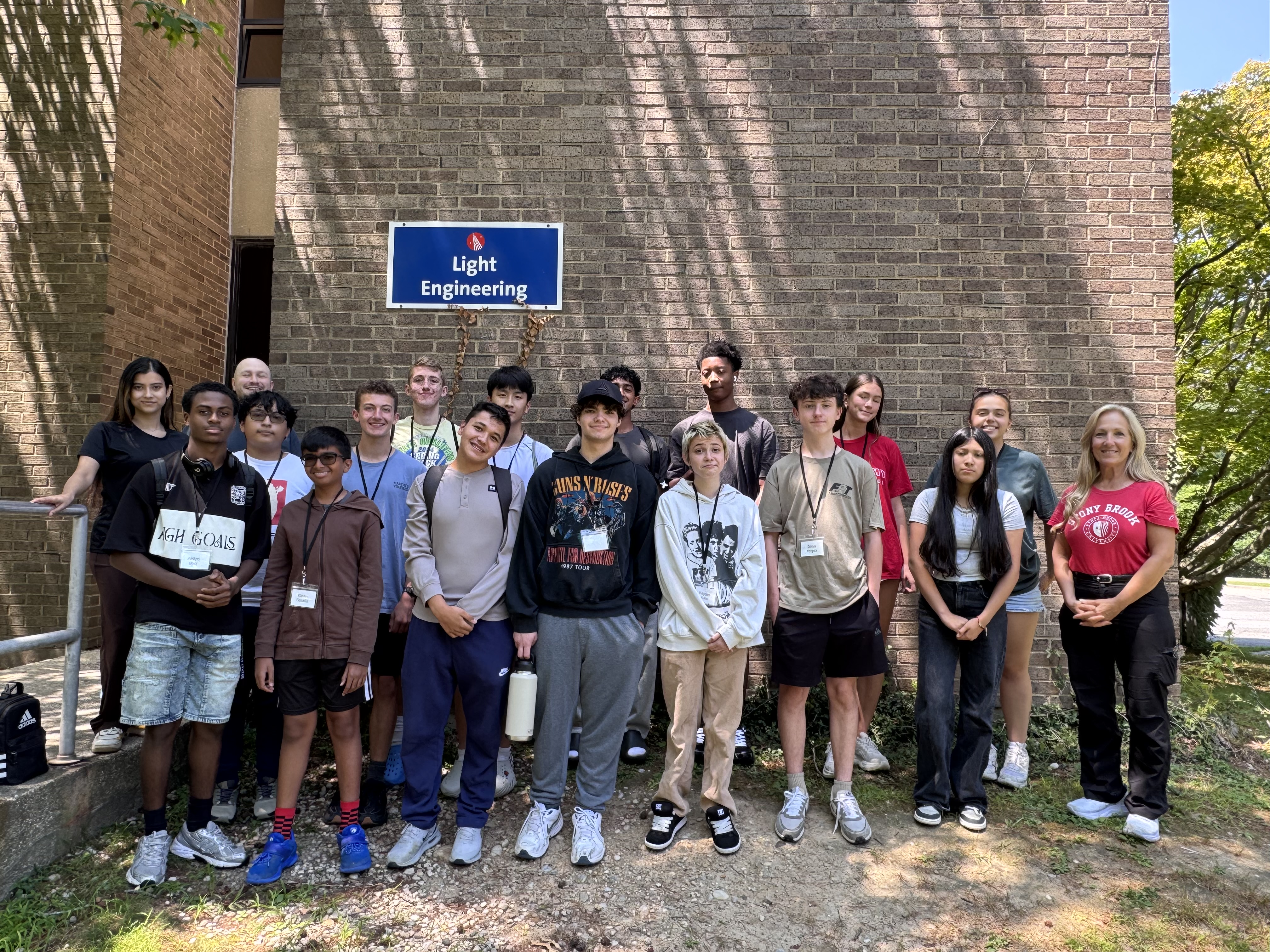 A large group of students standing in front of the Light Engineering Building at Stony Brook University.