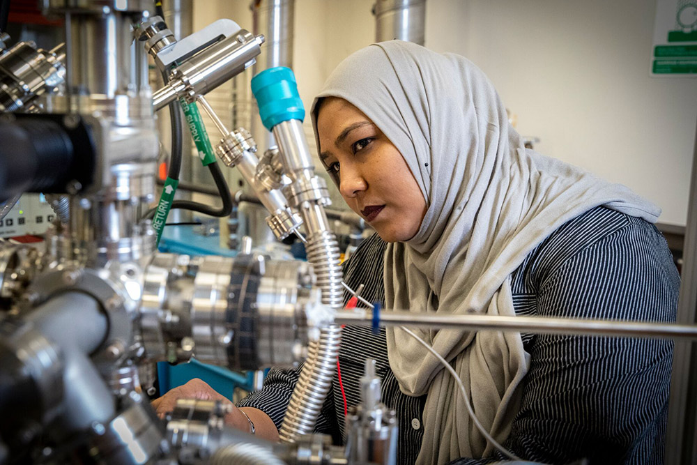 Student working intently on a project in a lab.